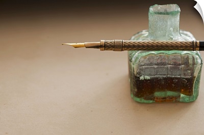 Close up of antique ink well and pen