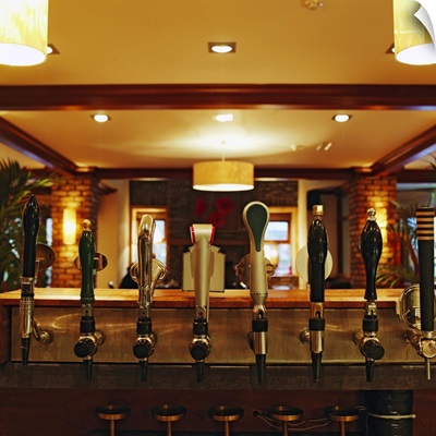 Close-up of beer taps in bar