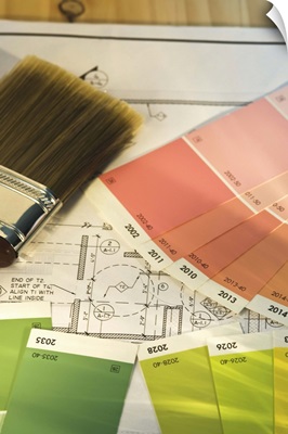 Close up of blueprint and painting supplies