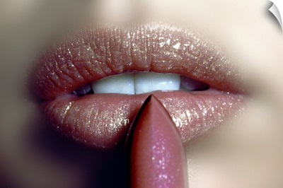 Close-up of woman applying a glitter lipstick