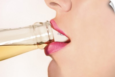 Close-up profile view of a woman's lips drinking from a bottled beer