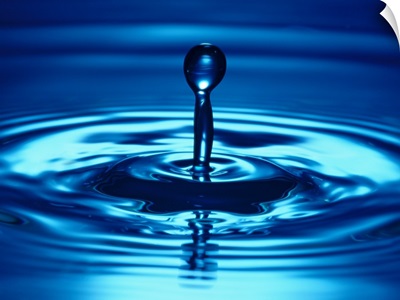 close-up view of a water drop rising from the surface of a water body