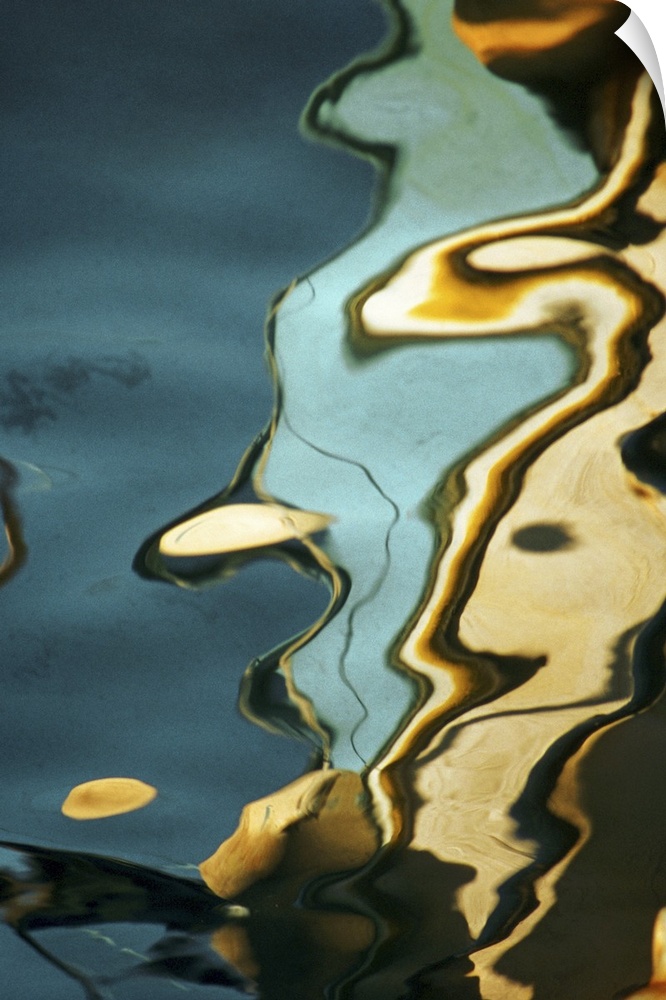 Big, vertical abstract photograph of colorful swirls and reflections in a waving body of water.