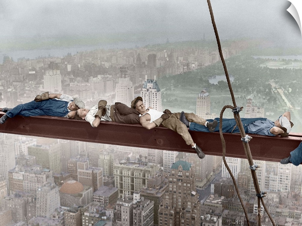 Four construction workers take a nap, balanced on a steel girder hung 800 feet over Manhattan, during the construction of ...