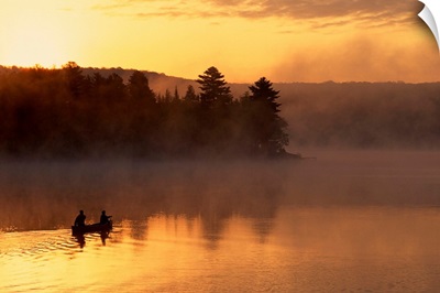 Couple canoeing in early morning