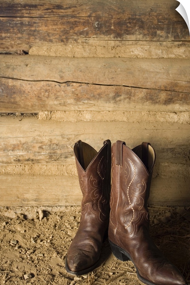 Cowboy boots near door to barn