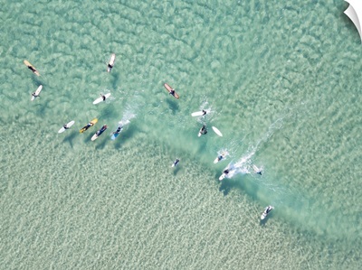 Crystal Clear Waters With Surfers Seen From Above