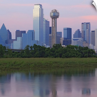 Dallas skyline reflected in water at sunset.