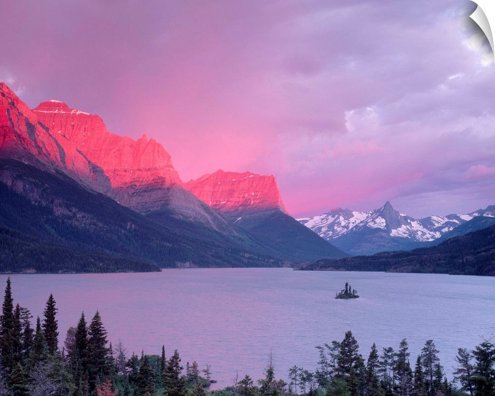 Dawn sunlight illuminates the Rocky Mountains above Saint Mary Lake.