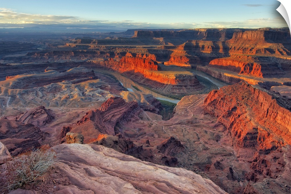 Large photo on canvas of red rock formations in Utah bathed in sunlight from a rising sun.