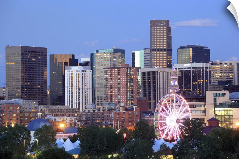 Denver, Colorado skyline at dusk with theme park ride in foreground
