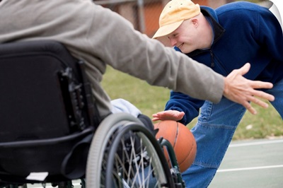 Disabled man playing basketball with his son
