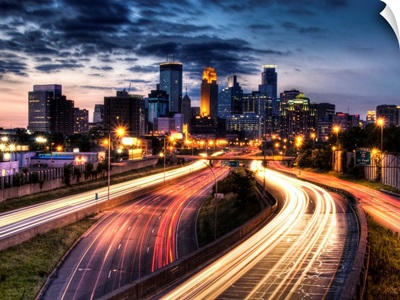 Downtown Minneapolis skyline and light trails on road