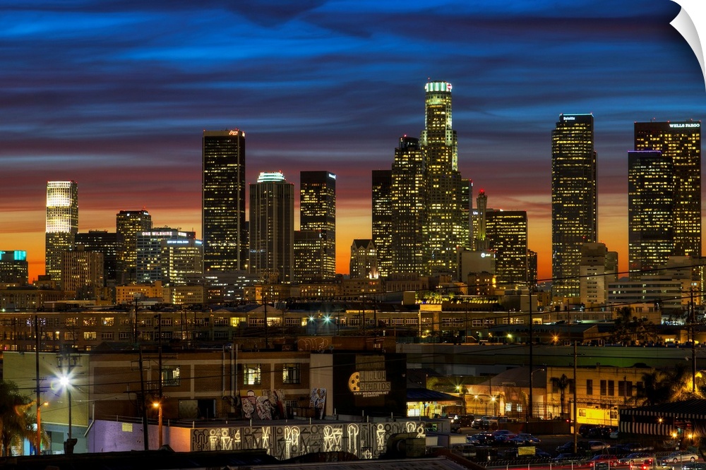 Huge photograph displays a busy city as the sun begins to set on the nicknamed "City of Angels" in California.  The smalle...
