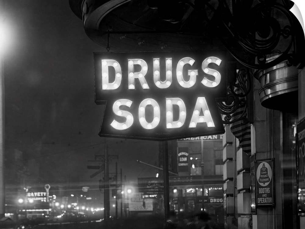 The sign above the Firemen's Drug Store that indicates Drugs and Soda is illuminated by 110-5 watt Mazda sign lamps.