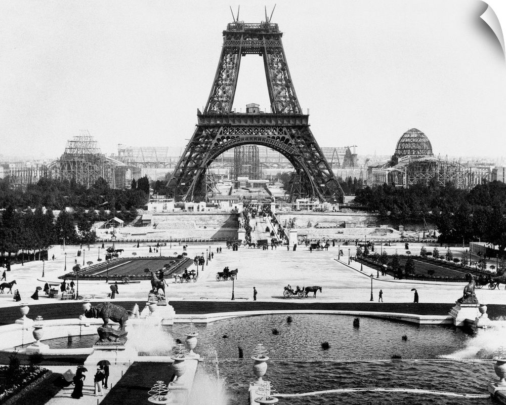 The Eiffel Tower being constructed halfway up with surrounding exhibition area. Undated photograph.