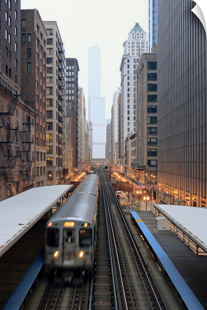 Vertical panoramic photograph of railway lined with tall buildings and skyscrapers.