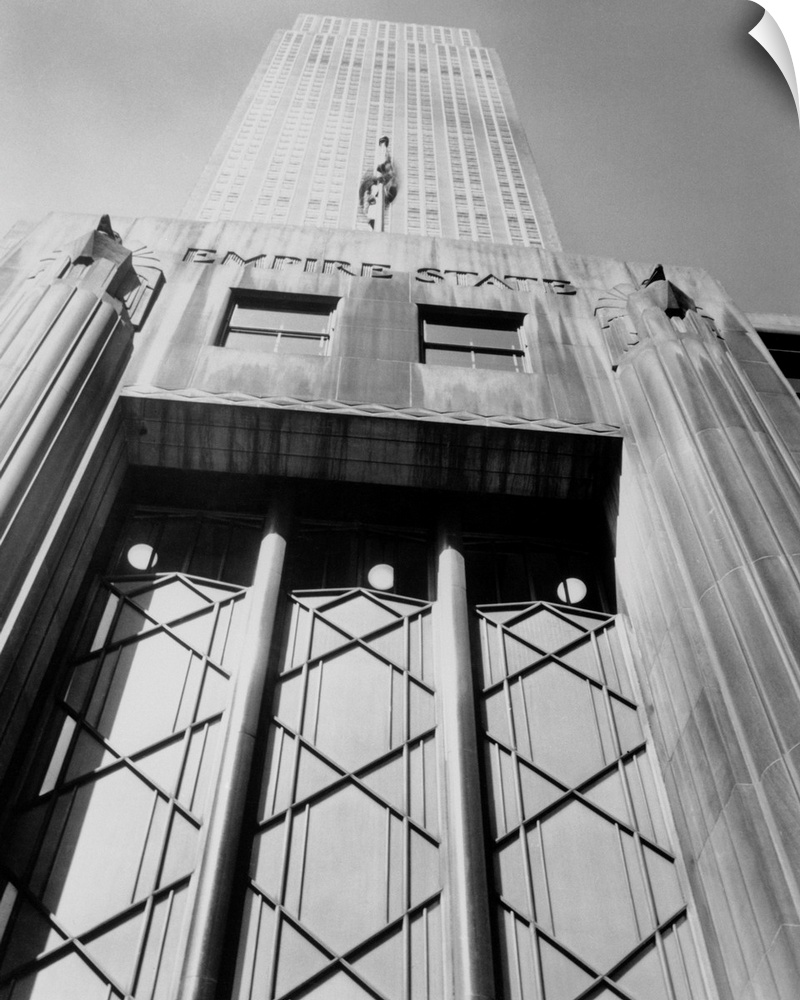 Empire State Building in New York City as seen from the sidewalk looking up.