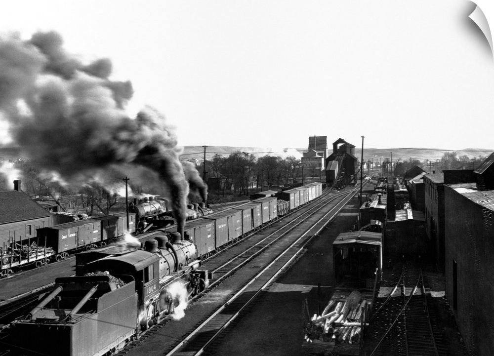 A locomotive pours smoke as it travels through the railroad yard in Minot, North Dakota.