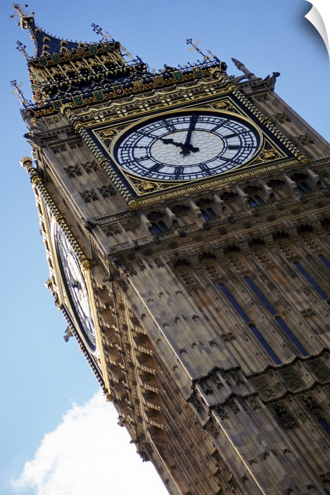 Big Ben is photographed from below showing mostly the top of the structure at an angle.