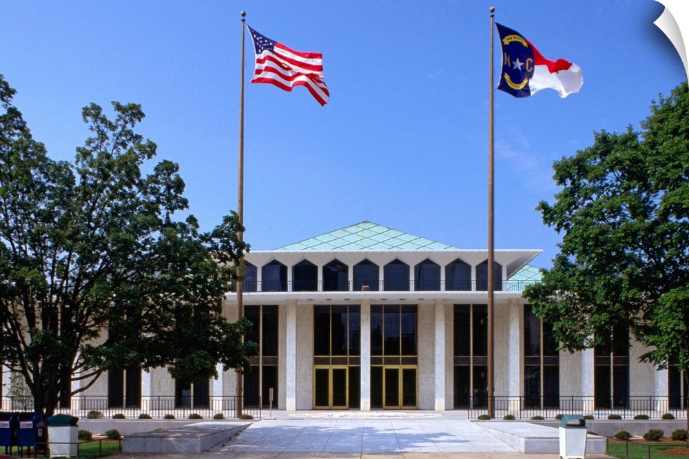 Raleigh, North Carolina, United States, North America. The flags of NC and the USA fly above the building.