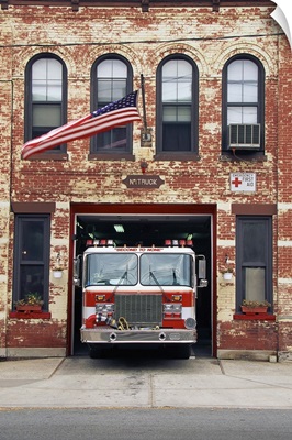 Fire engine parked in a small town firehouse