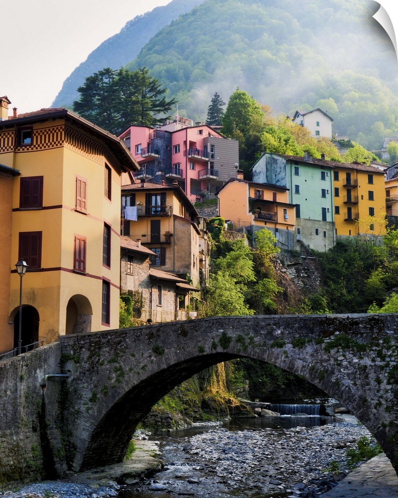 Fog drifts down mountain and through idealistic village along Lake Como.