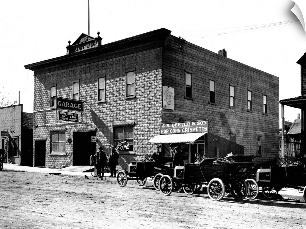 New model Fords are parked oustside the Dolloff building, housing a garage and Ford dealership, Minot, North Dakota, ca. 1...