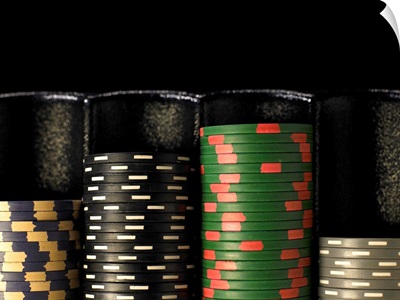 Gambling chips stacked in dispenser, close-up