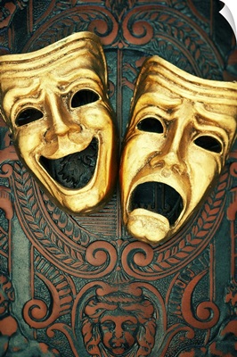 Golden comedy and tragedy masks on patterned leather