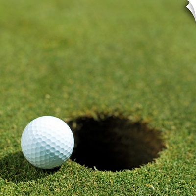 Golf ball on the edge of the hole