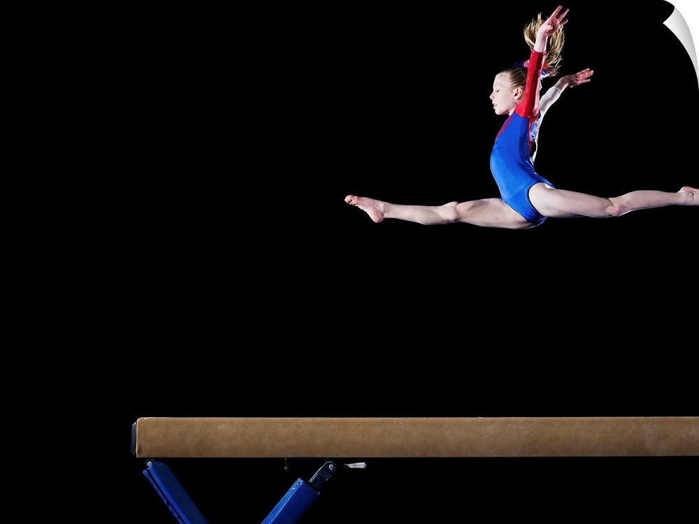 Gymnast (9-10) leaping on balance beam