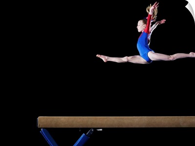 Gymnast leaping on balance beam