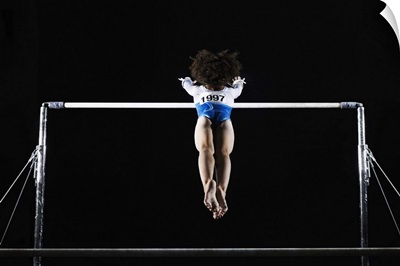 Gymnast reaching for uneven bars