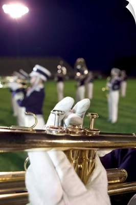Hands playing trumpet in marching band