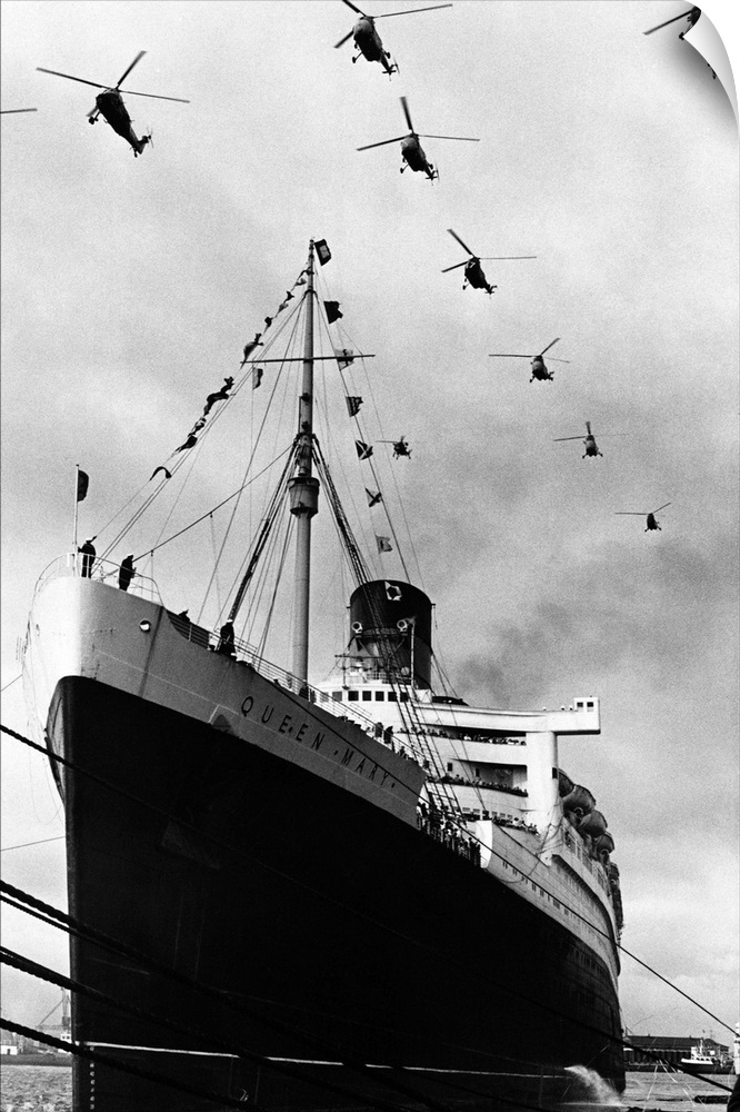 Royal Navy helicopters fly in formation over the Cunard liner Queen Mary as she leaves Southampton on the last voyage of h...