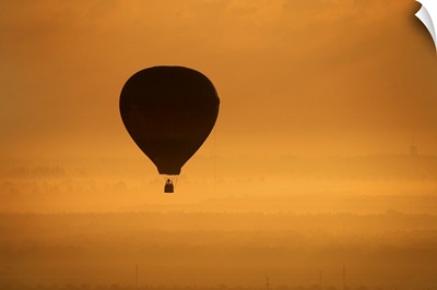 Hot air balloon flying at dusk