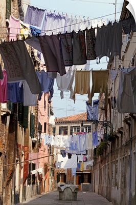 Italy, Venice, lines of washing hanging between buildings in sunny street