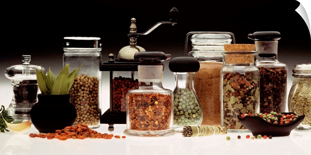 Landscape, large photograph of a variety of herbs and spices in numerous types of jars and grinders.