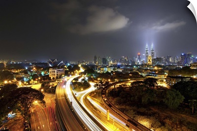 Kuala Lumpur skyline and long exposure road at dusk.
