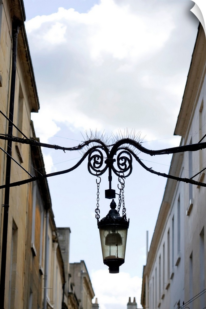Lamp hanging between buildings