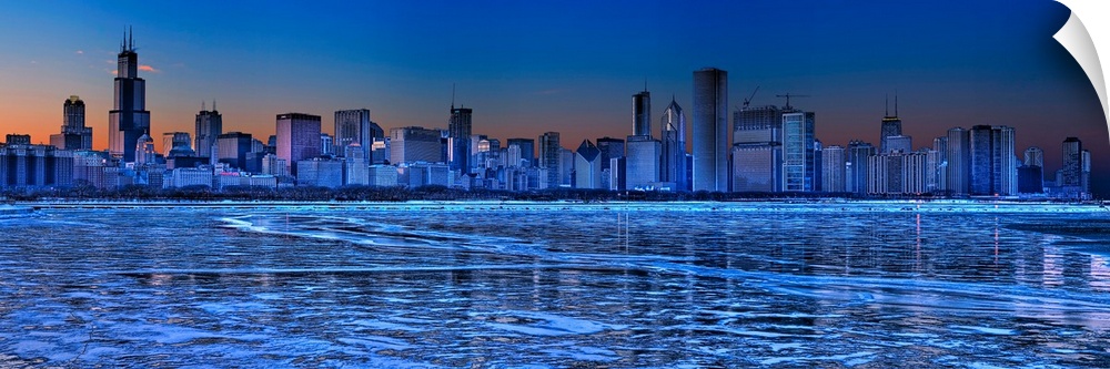 Large, landscape photograph of the icy waters of Lake Michigan in front of the Chicago skyline at dusk.