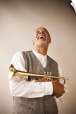 Laughing musician holding trumpet