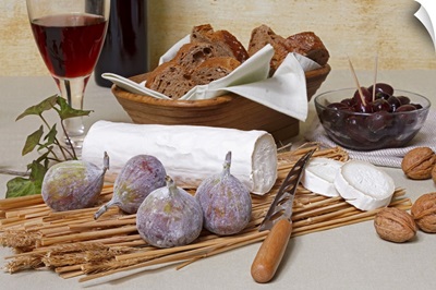 Log of goat's cheese with figs, nuts, olives, bread and red wine