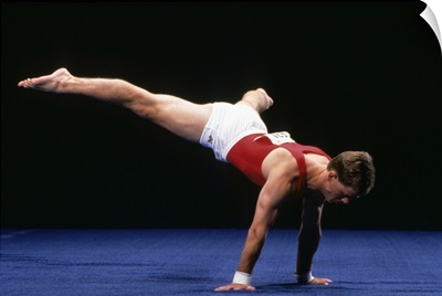 Male gymnast peforming a routine in the floor exercise