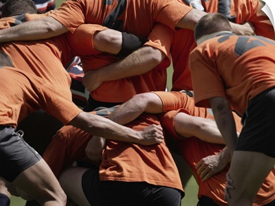 Male rugby players in scrum, rear view