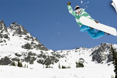 male snowboarder jumping in air