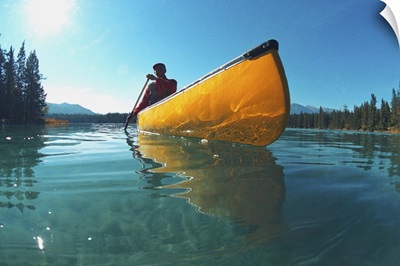 Man in yellow canoe on lake