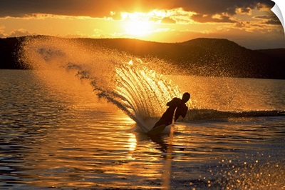 Man waterskiing at dusk
