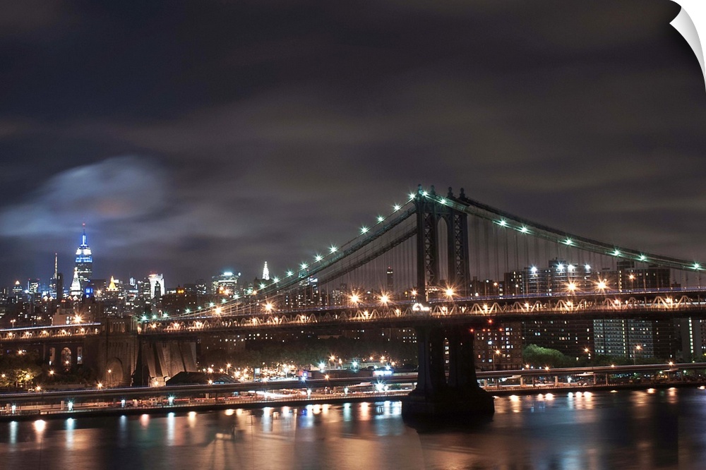 Night time long exposure taken from the Brooklyn Bridge facing uptown looking at the Manhattan Bridge with the Empire Stat...